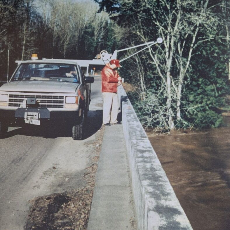 USGS technicians, Len Reed and Mike DeVolder, measuring the flood peak on the Tualatin River at West Linn on February 10, 1996.